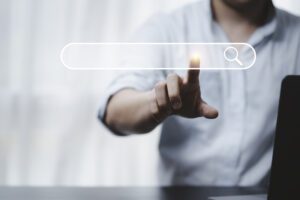 Hand touching with search icon for Search Engine Optimisation or