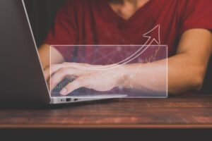 Businessmen are training stocks showing a hologram.