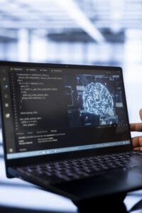 Computer scientist using laptop in data center, updating AI