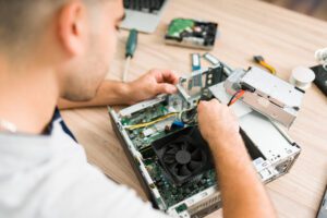 Latin man checking the hardware of a computer